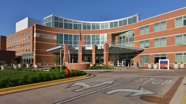 Brick and glass main entrance of Suburban Hospital in Bethesda, Maryland.